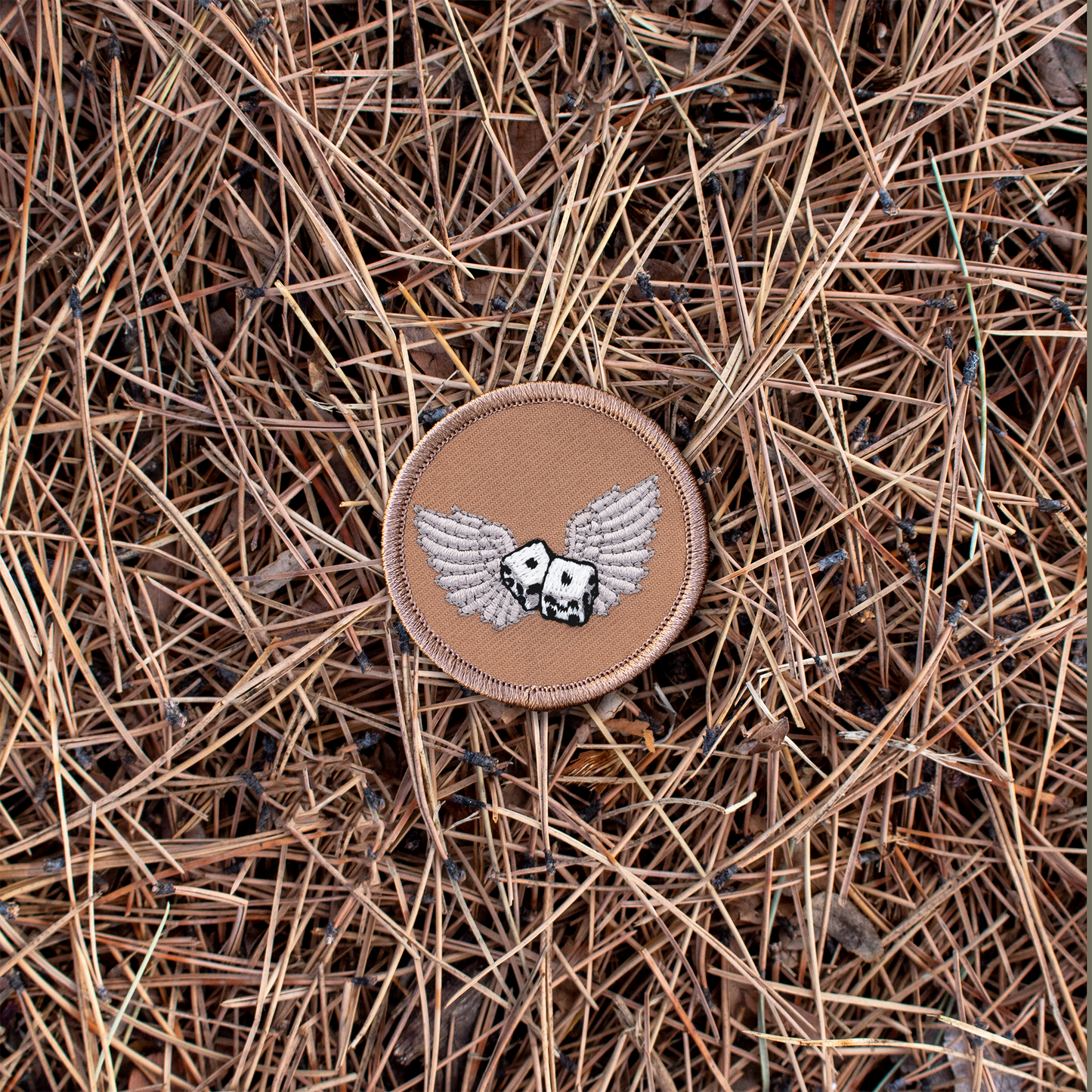 Winged dice iron-on scout patch